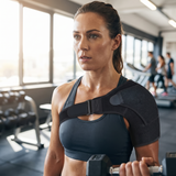 Woman training at the gym wearing the shoulder brace