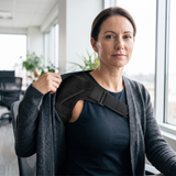 Woman wearing the shoulder support under her cardigan