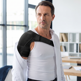 Man wearing the shoulder support under his dress shirt