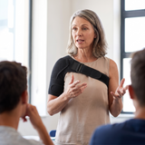 Teaching a class wearing the shoulder support