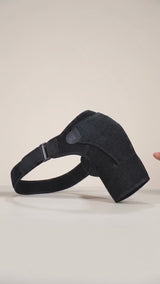 The velcro strap being fastened over the pressure pad