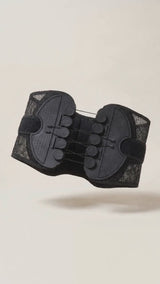 Cord tensioners being tightened on the lumbar belt